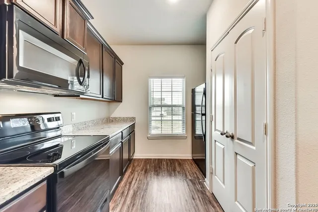 a kitchen with stainless steel appliances granite countertop a stove and a microwave