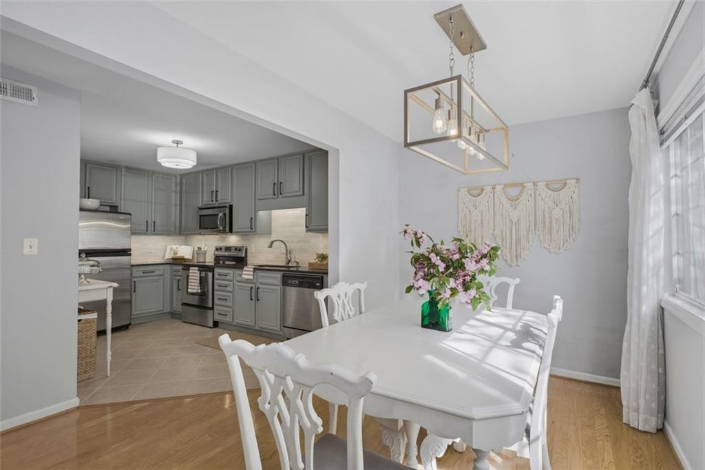 1468 Briarwood Road Northeast, Unit 901 Atlanta, GA 30319 - Photo 12 of 27 a dining room with furniture and window