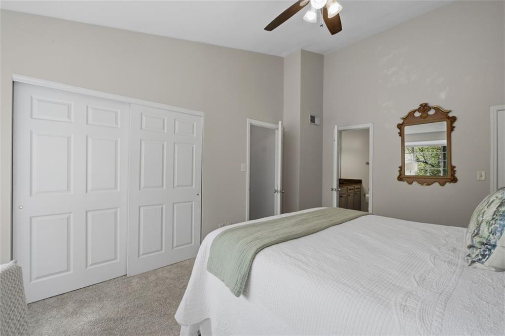 1468 Briarwood Road Northeast, Unit 901 Atlanta, GA 30319 - Photo 18 of 27 a bedroom with a bed and a chandelier
