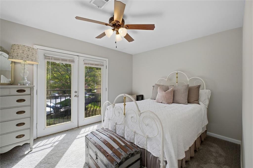 1468 Briarwood Road Northeast, Unit 901 Atlanta, GA 30319 - Photo 20 of 27 a bedroom with a bed a large window with balcony view