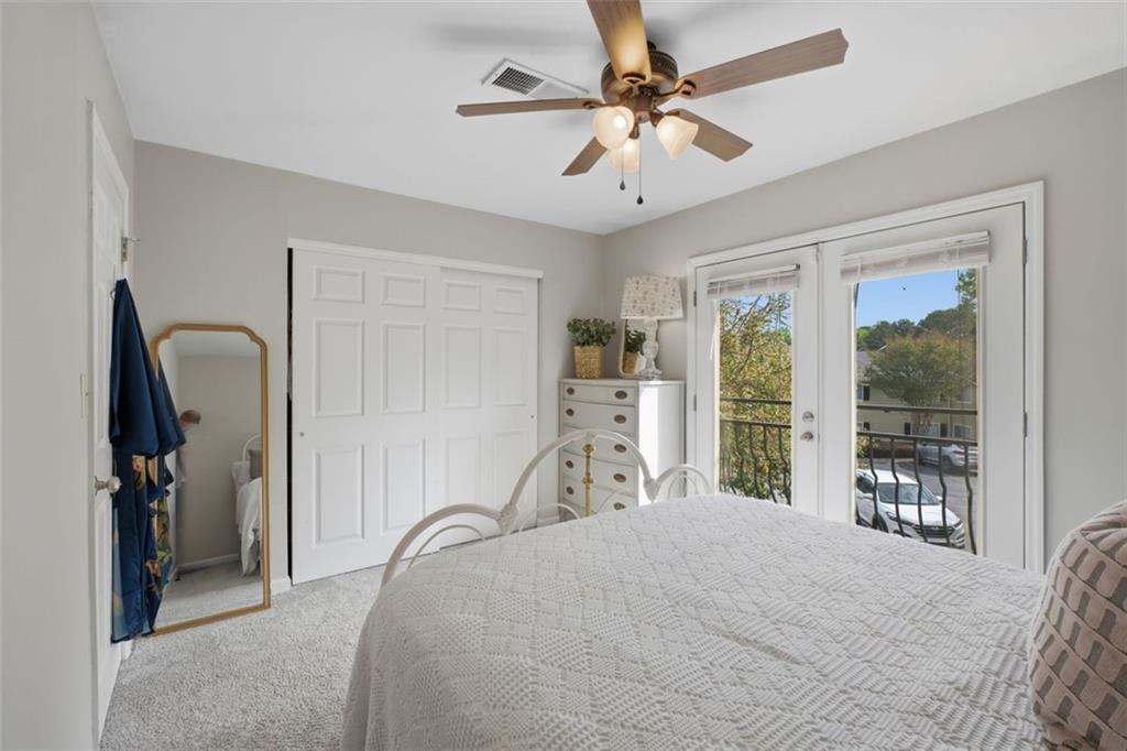 1468 Briarwood Road Northeast, Unit 901 Atlanta, GA 30319 - Photo 22 of 27 a bedroom with a large bed and a chandelier