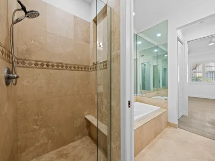 a bathroom with a bathtub and shower