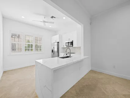 a view of kitchen with center island and sink