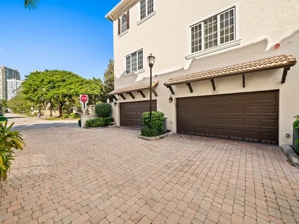 a front view of a house with a yard and a garage