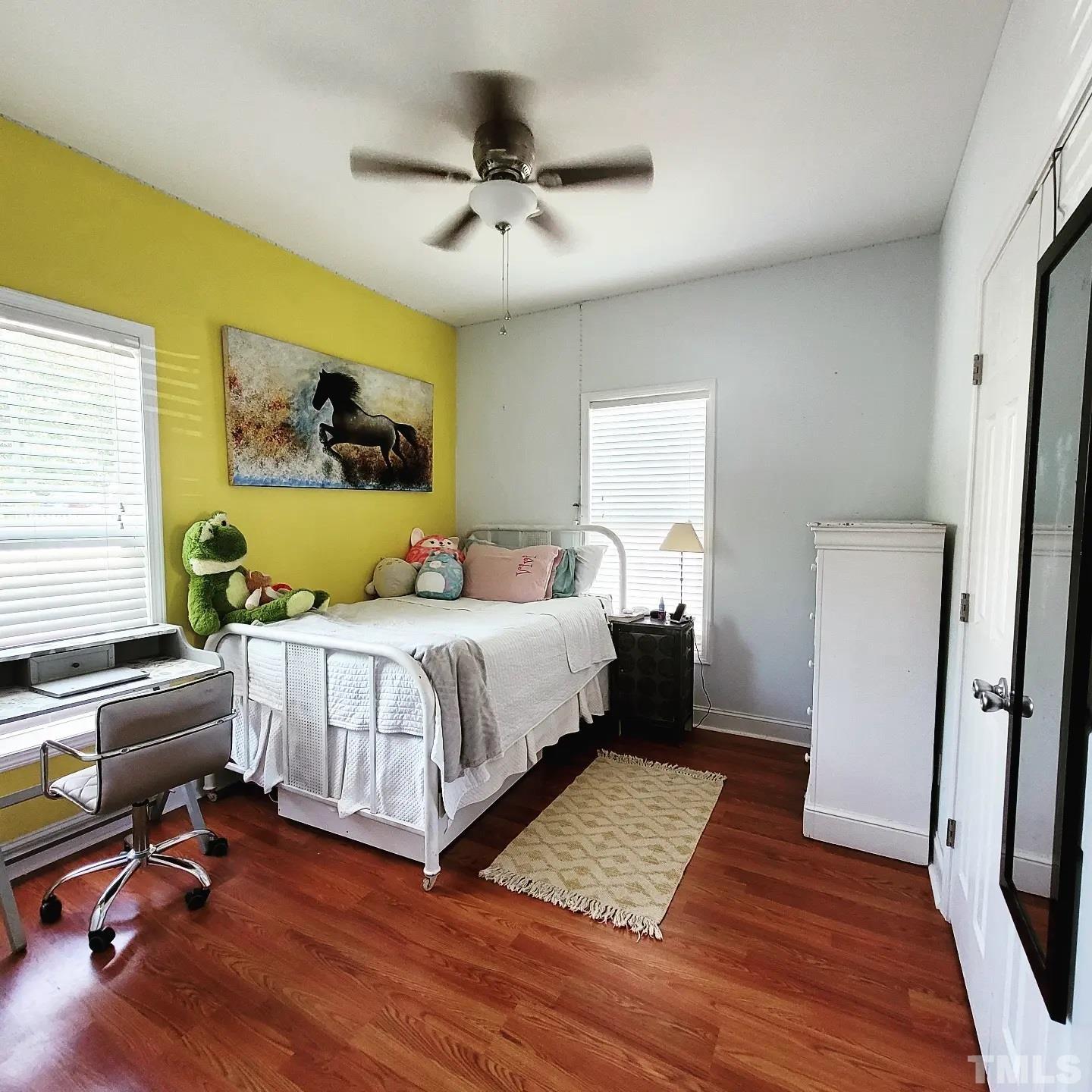 701 East Martin Street Raleigh, NC 27601 - Photo 8 of 15 a bedroom with a bed a couch and a window