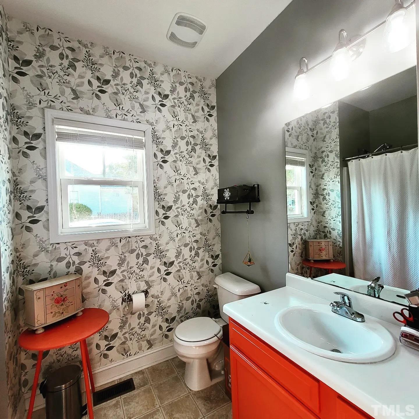 701 East Martin Street Raleigh, NC 27601 - Photo 9 of 15 a bathroom with a sink toilet and mirror