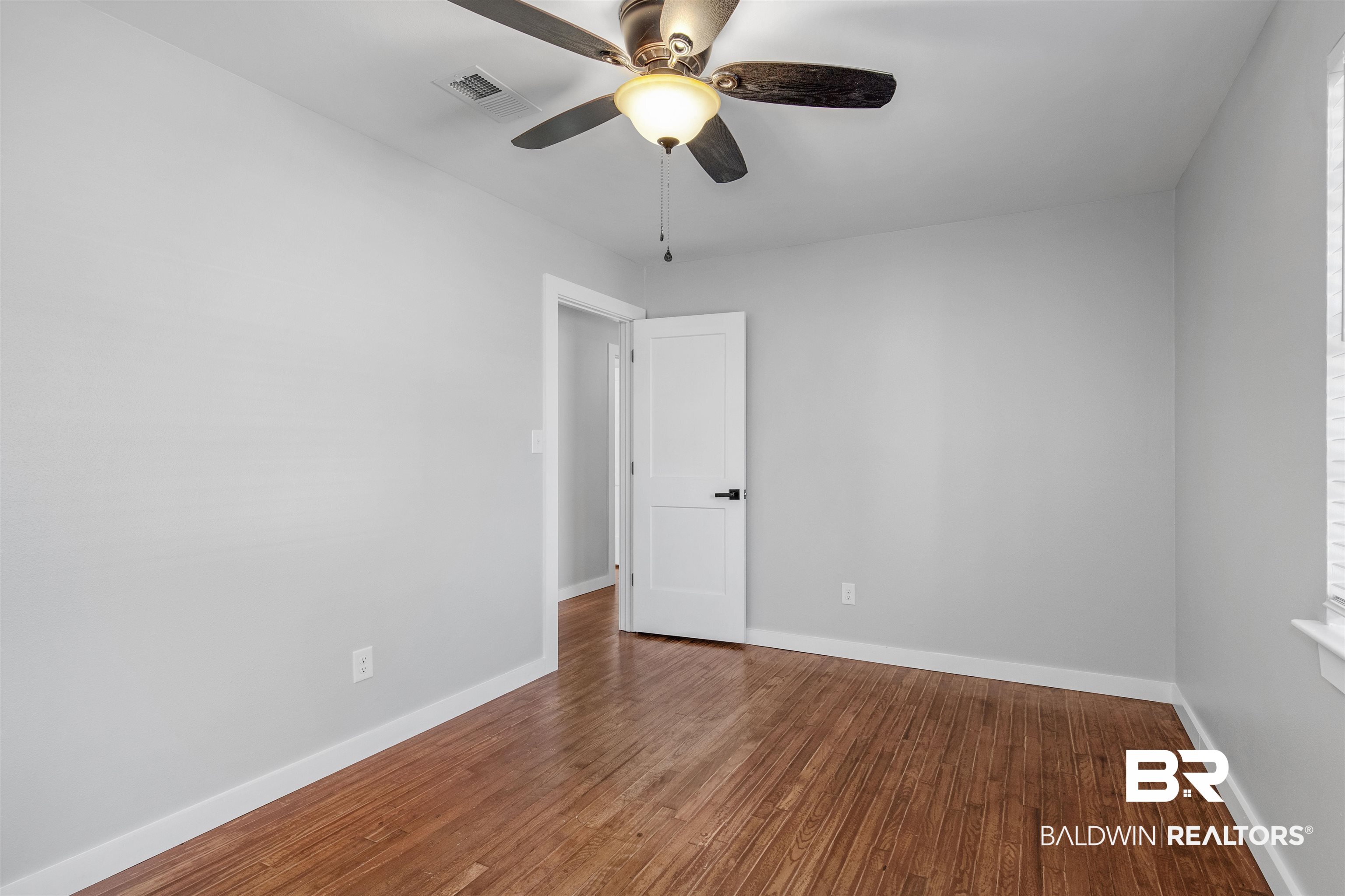 3005 Club House Road Mobile, AL 36605 - Photo 13 of 20 Empty room with ceiling fan and wood-type flooring