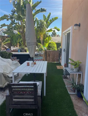 a view of a patio with table and chairs and potted plants