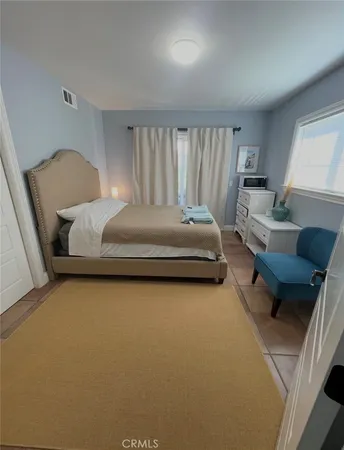 a bedroom with bed and window