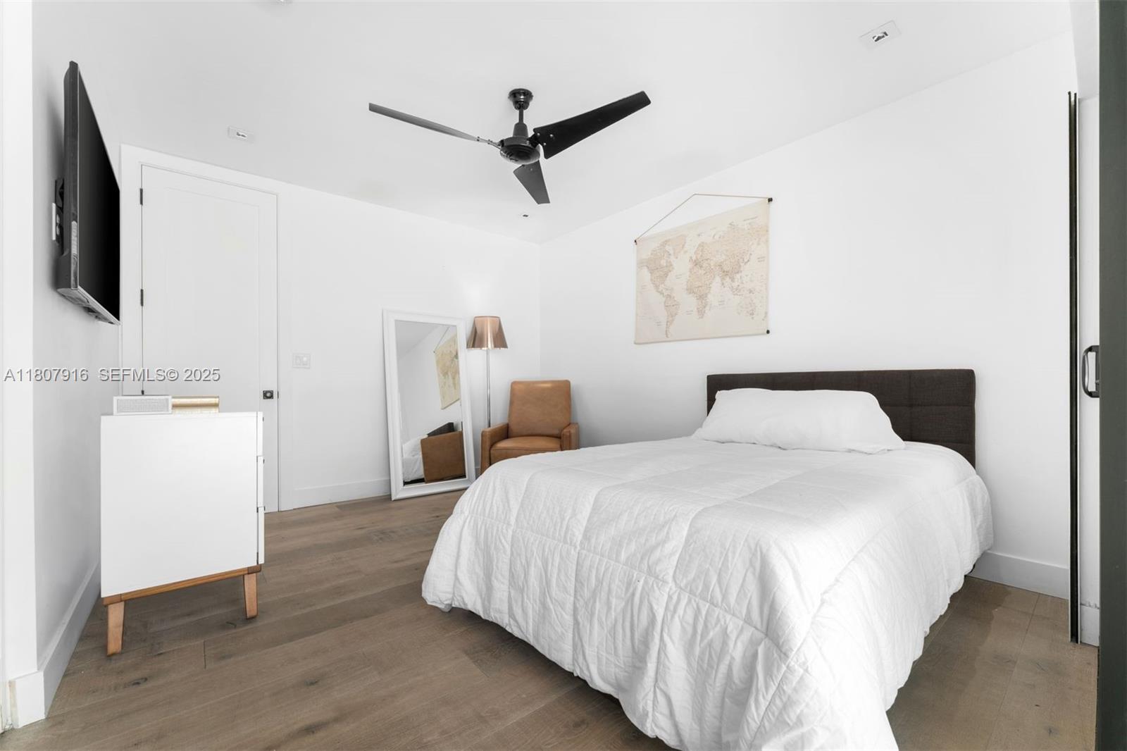 4250 Bay Point Road Miami, FL 33137 - Photo 22 of 43 a spacious bedroom with a bed and a flat screen tv