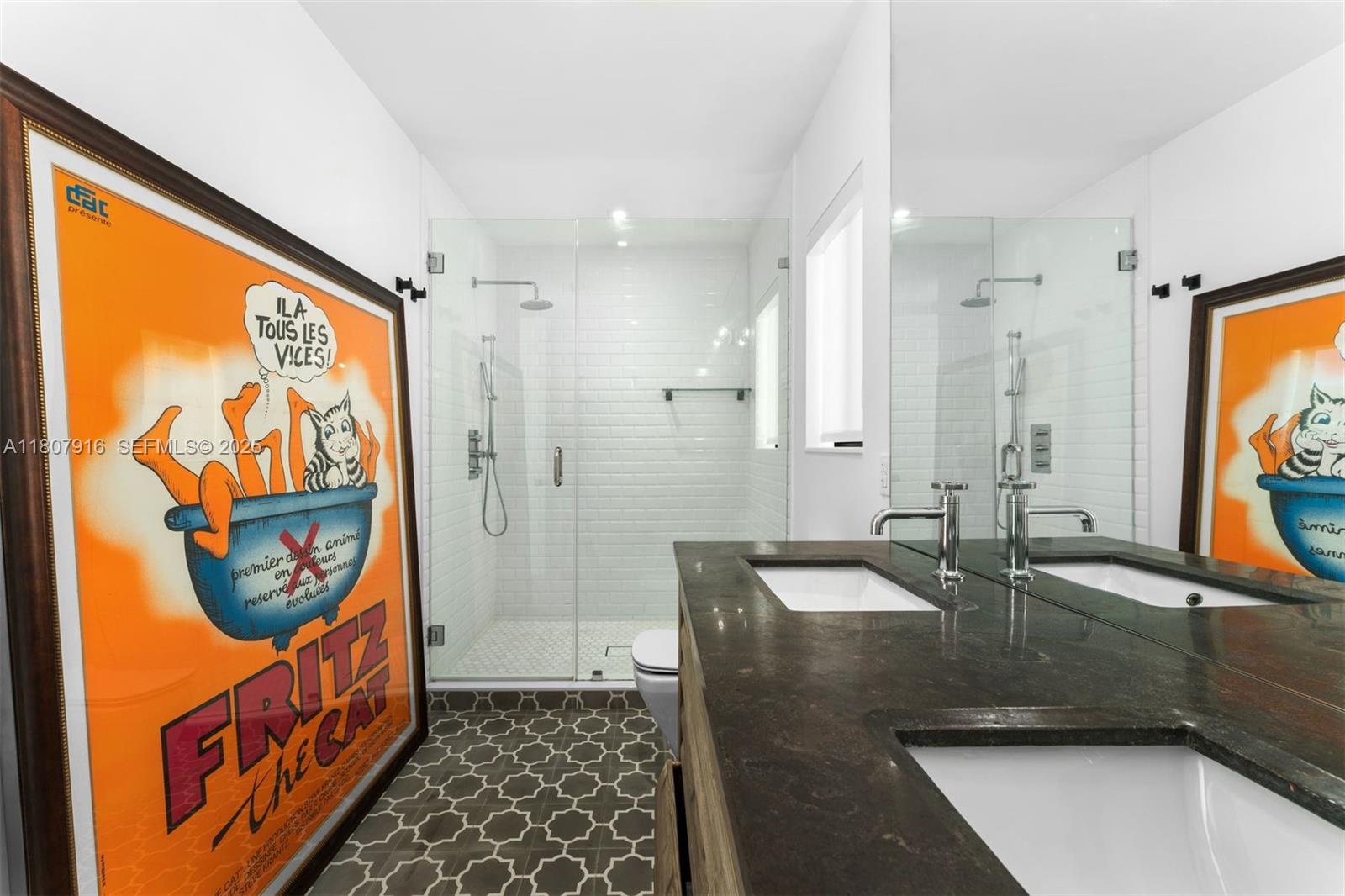 4250 Bay Point Road Miami, FL 33137 - Photo 28 of 43 a bathroom with a sink a mirror and a shower