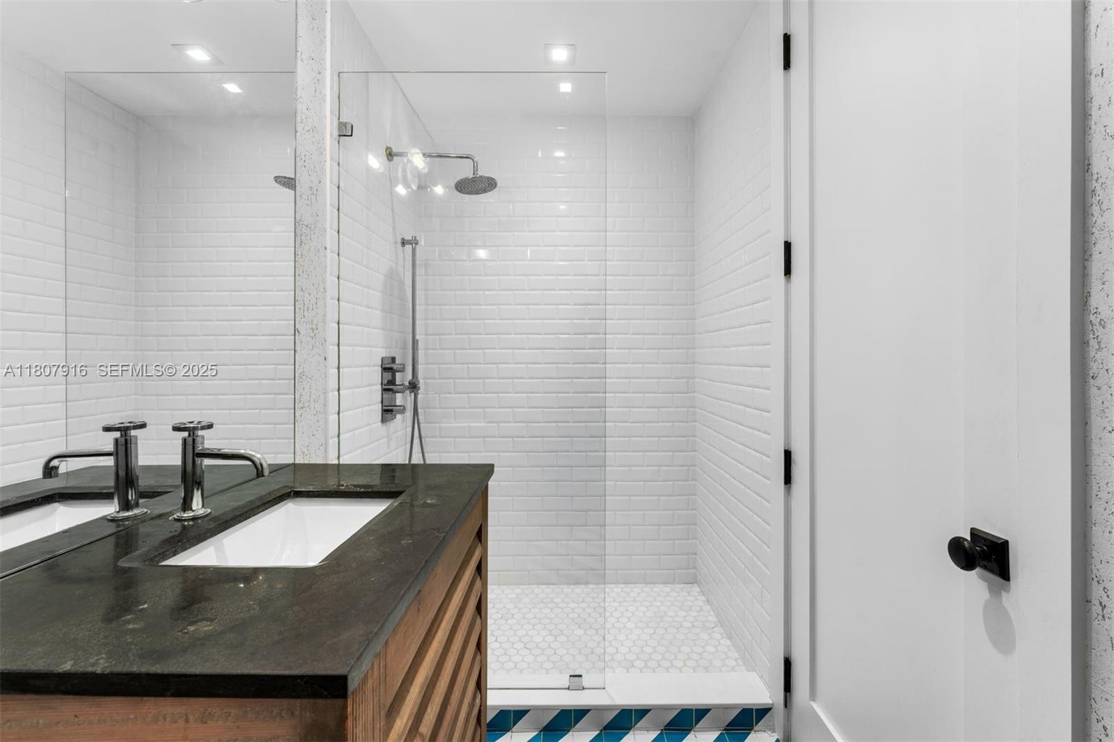 4250 Bay Point Road Miami, FL 33137 - Photo 29 of 43 a bathroom with a granite countertop sink a toilet a mirror and shower