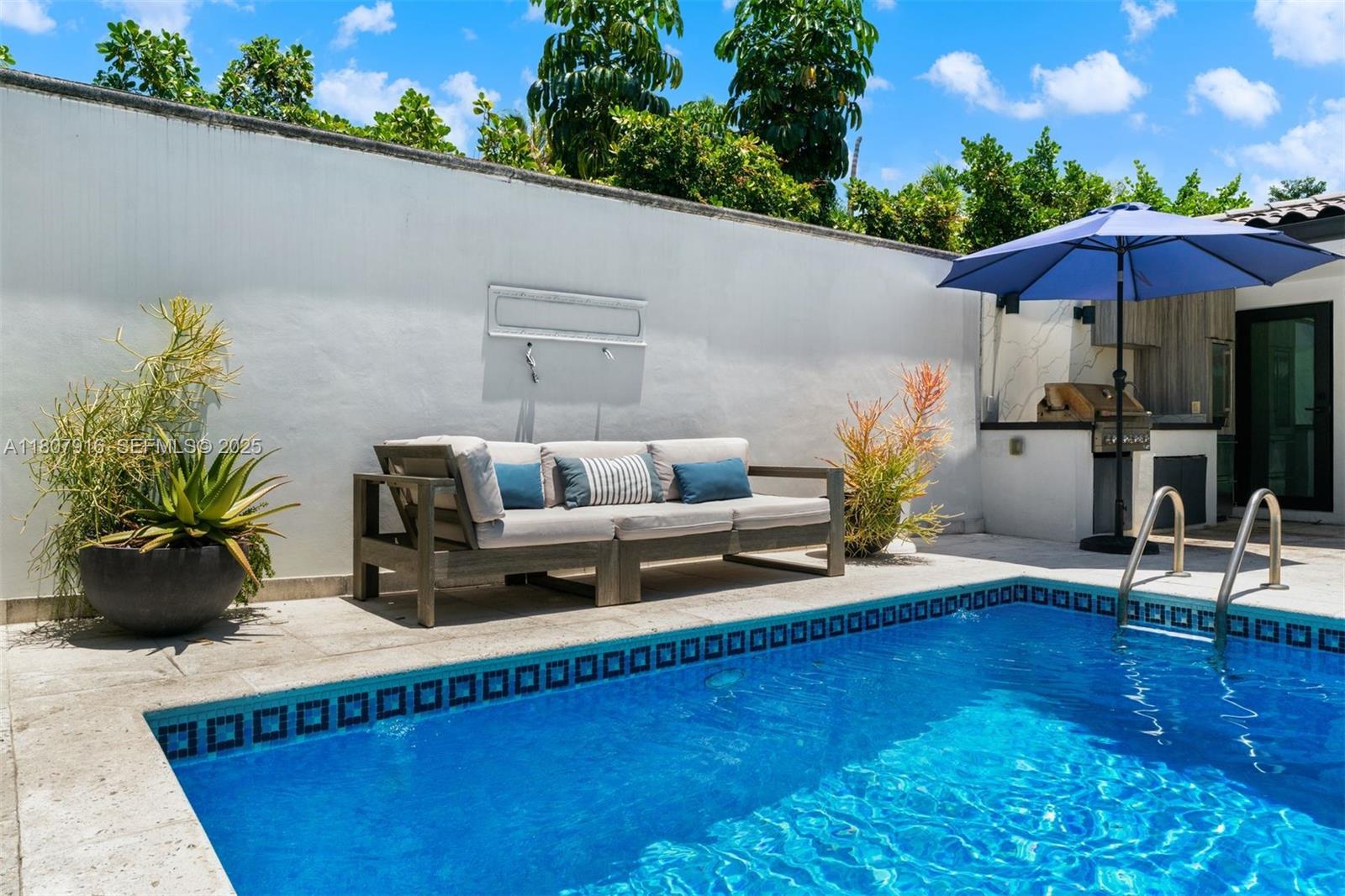 4250 Bay Point Road Miami, FL 33137 - Photo 41 of 43 a living room with furniture and a potted plant