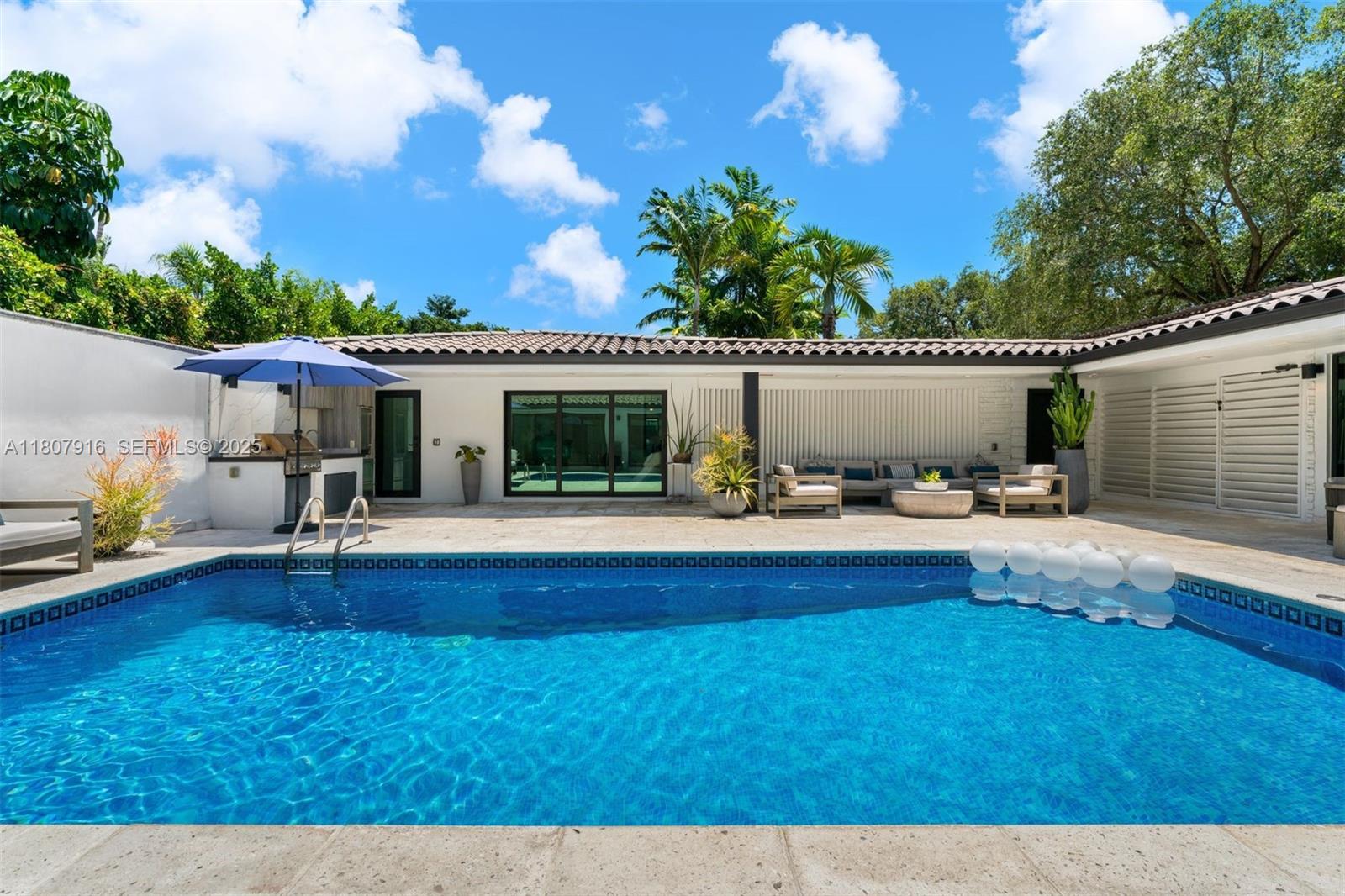 4250 Bay Point Road Miami, FL 33137 - Photo 42 of 43 a view of a house with swimming pool and sitting area