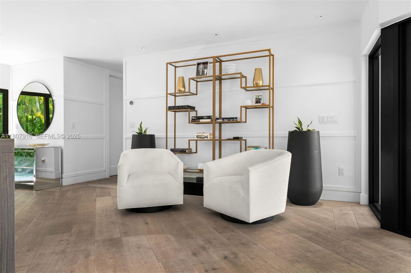 4250 Bay Point Road Miami, FL 33137 - Photo 7 of 43 a living room with couches and painting on the wall