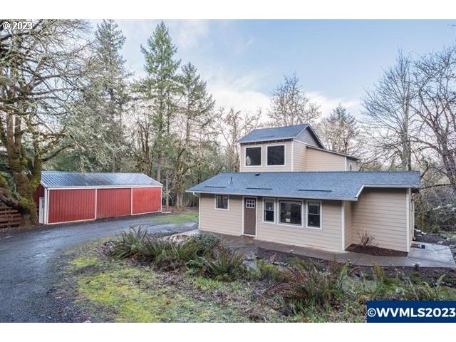 6057 Treehouse Road Monmouth, OR 97361 - Photo 1 of 32 a front view of a house with yard and trees