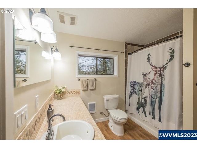 6057 Treehouse Road Monmouth, OR 97361 - Photo 14 of 32 a bathroom with a granite countertop sink mirror vanity and toilet