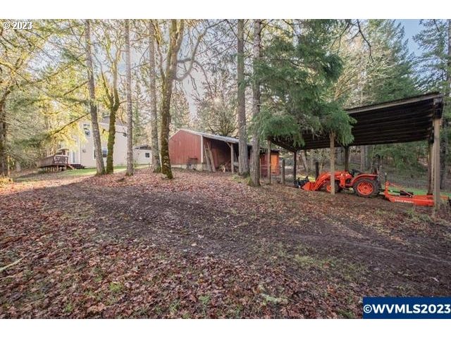 6057 Treehouse Road Monmouth, OR 97361 - Photo 20 of 32 a backyard of a house with table and chairs