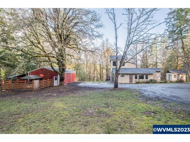 6057 Treehouse Road Monmouth, OR 97361 - Photo 24 of 32 a view of a yard with a house and a tree