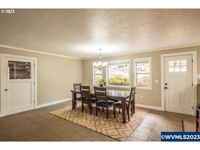 6057 Treehouse Road Monmouth, OR 97361 - Photo 25 of 32 a view of a dining room with furniture and chandelier