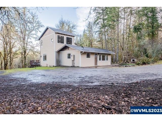 6057 Treehouse Road Monmouth, OR 97361 - Photo 26 of 32 a view of a house with a yard