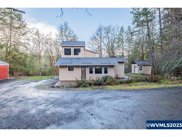 6057 Treehouse Road Monmouth, OR 97361 - Photo 27 of 32 a view of a yard in front of a house with large trees