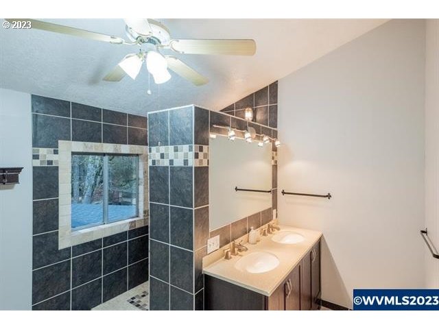 6057 Treehouse Road Monmouth, OR 97361 - Photo 30 of 32 a bathroom with a sink mirror and shower
