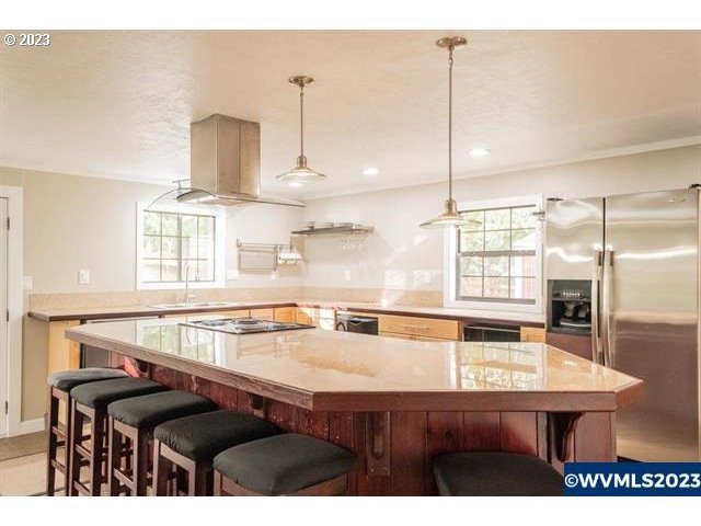 6057 Treehouse Road Monmouth, OR 97361 - Photo 31 of 32 a kitchen with kitchen island a sink table and chairs
