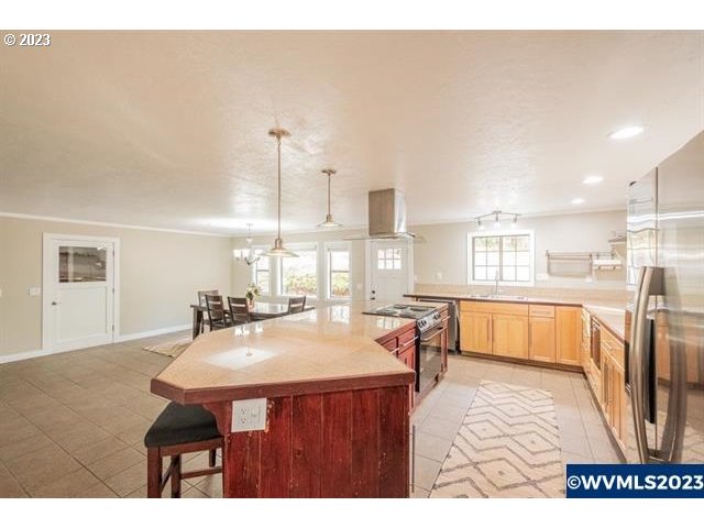 6057 Treehouse Road Monmouth, OR 97361 - Photo 32 of 32 a dining hall with stainless steel appliances a dining table and chairs with wooden floor