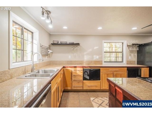 6057 Treehouse Road Monmouth, OR 97361 - Photo 4 of 32 a kitchen with kitchen island granite countertop a stove a sink and a refrigerator