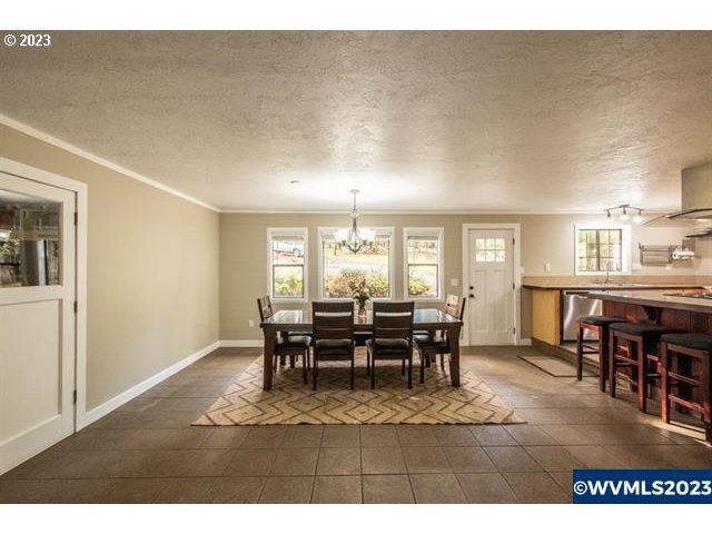 6057 Treehouse Road Monmouth, OR 97361 - Photo 5 of 32 a dining room with furniture window and wooden floor