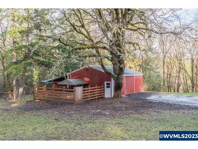 6057 Treehouse Road Monmouth, OR 97361 - Photo 7 of 32 a house is sitting in middle of the middle of a field