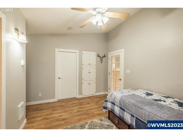 6057 Treehouse Road Monmouth, OR 97361 - Photo 10 of 32 a bedroom with a bed and a chandelier