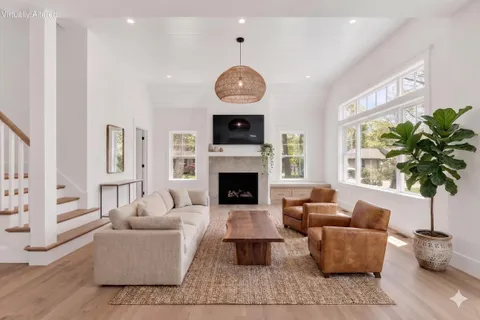 an empty room with windows and fireplace