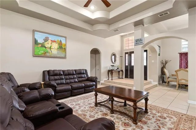 a living room with furniture a rug and a chandelier