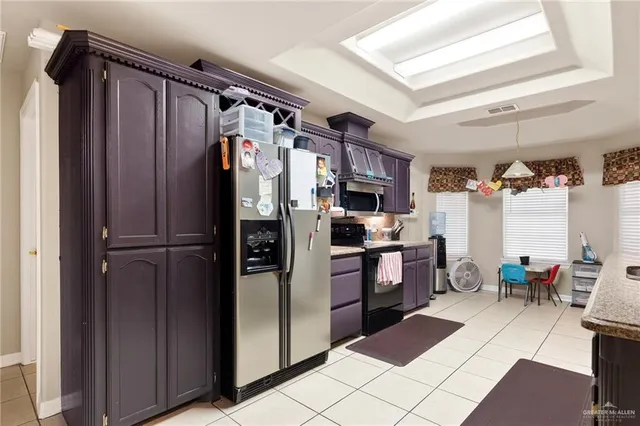 a kitchen with stainless steel appliances a refrigerator and a stove top oven