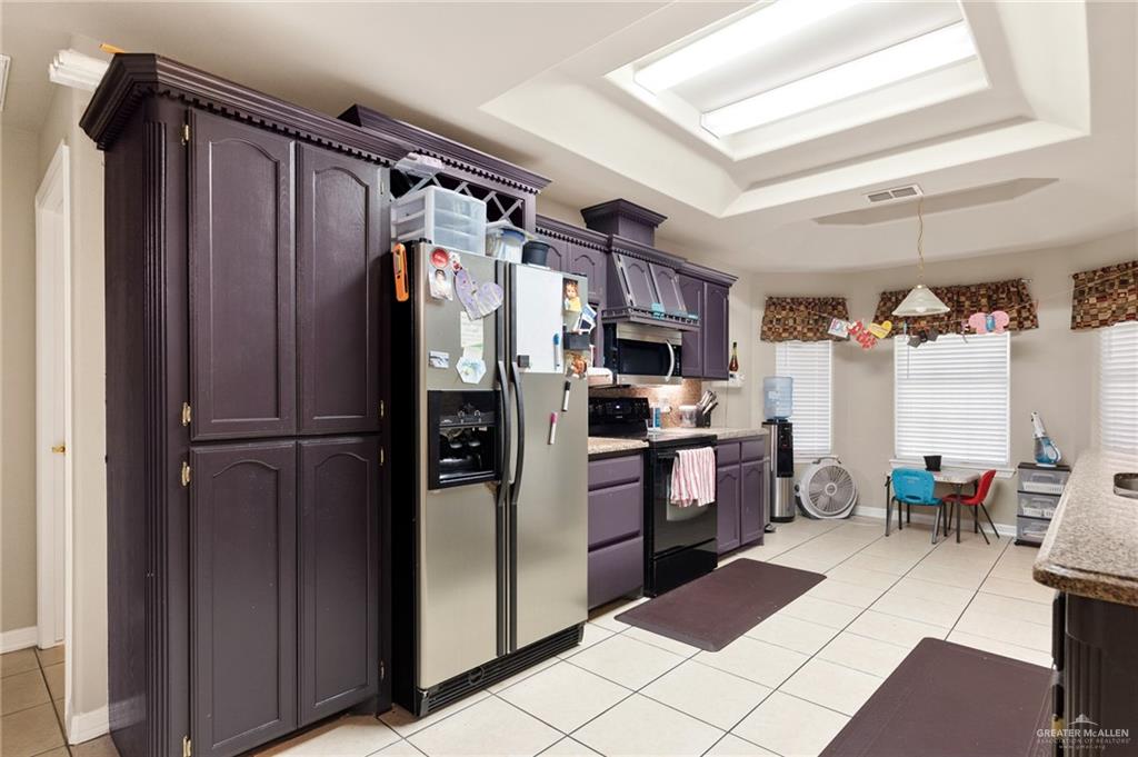 1311 Ima Street Edinburg, TX 78539 - Photo 6 of 11 a kitchen with stainless steel appliances a refrigerator and a stove top oven