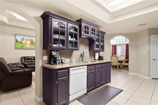 a kitchen with a stove a sink and a refrigerator