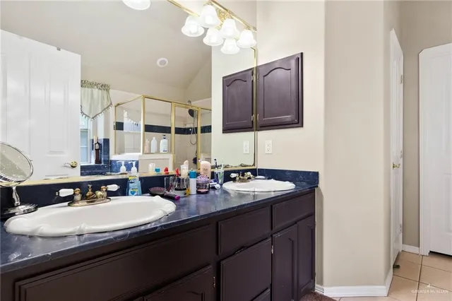 a bathroom with a sink double vanity and a mirror