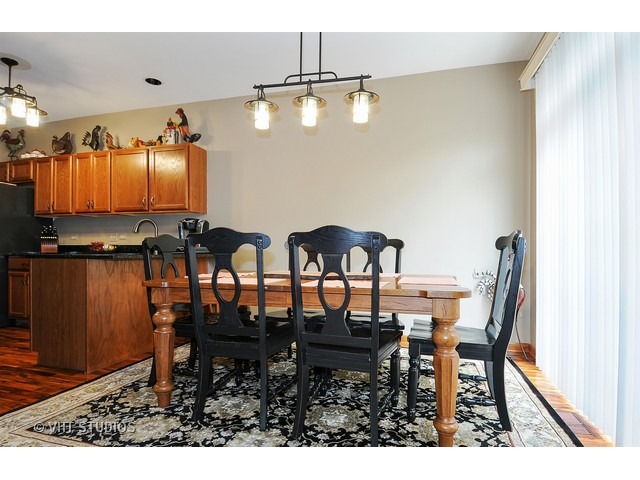 503 Goodwin Drive, Unit 503 Bolingbrook, IL 60440 - Photo 3 of 10 a view of a dining room with furniture and wooden floor