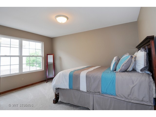 503 Goodwin Drive, Unit 503 Bolingbrook, IL 60440 - Photo 9 of 10 a bedroom with a bed and window
