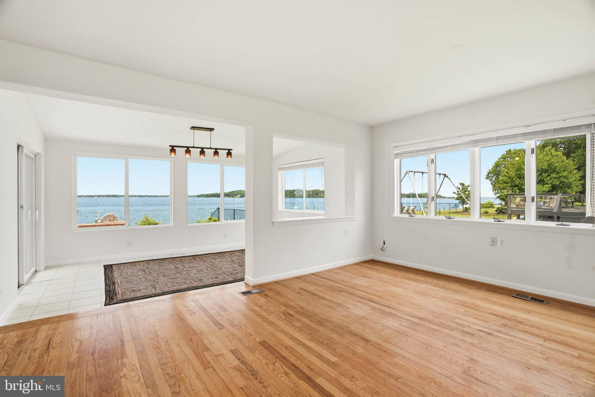 1100 River Bay Road Annapolis, MD 21409 - Photo 30 of 67 a view of an empty room with wooden floor and a window