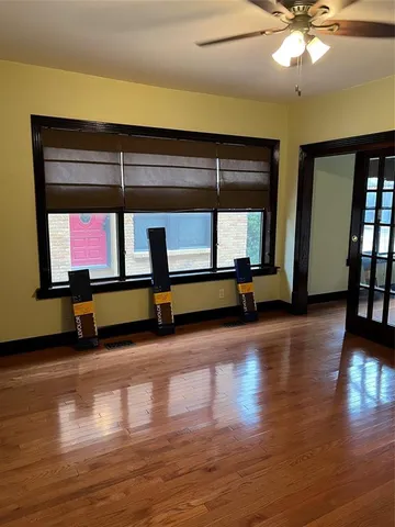a living room with couch and wooden floor