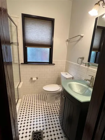 a bathroom with a sink toilet and mirror