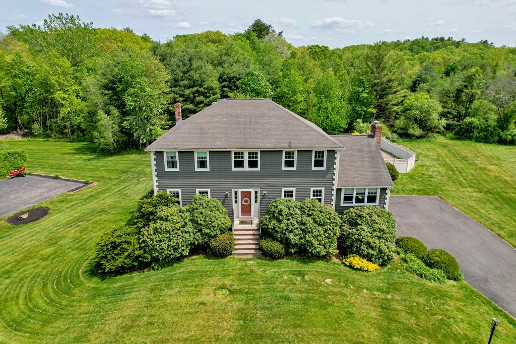 a aerial view of a house with yard and green space