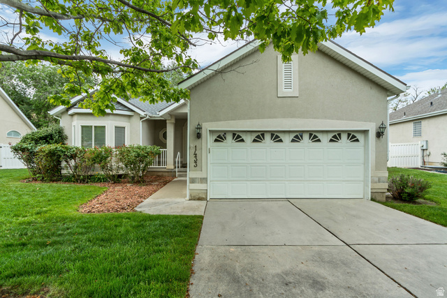 1433 Forge Way Draper, UT 84020 - Photo 3 of 29 Stucco exterior with a two-car garage featuring decorative transom windows and a concrete driveway