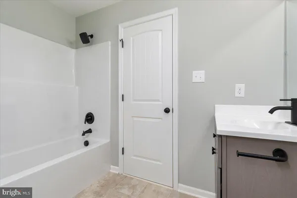 a bathroom with a tub and a sink
