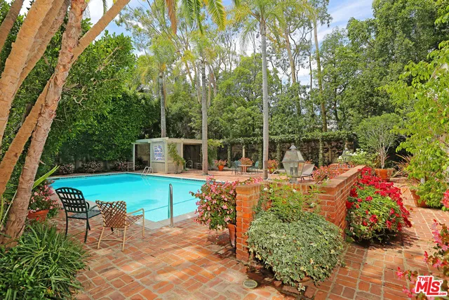 a view of a chair and tables in the patio