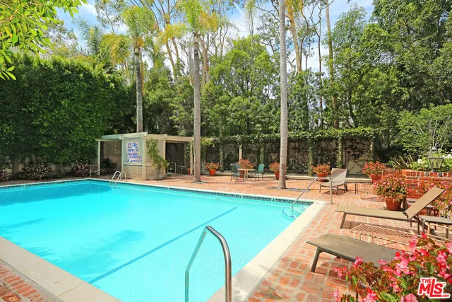 a view of a house with swimming pool and sitting area