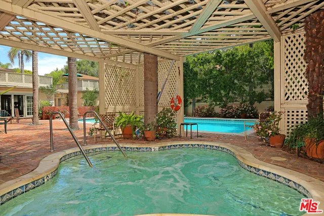 a view of a porch with a table and chairs